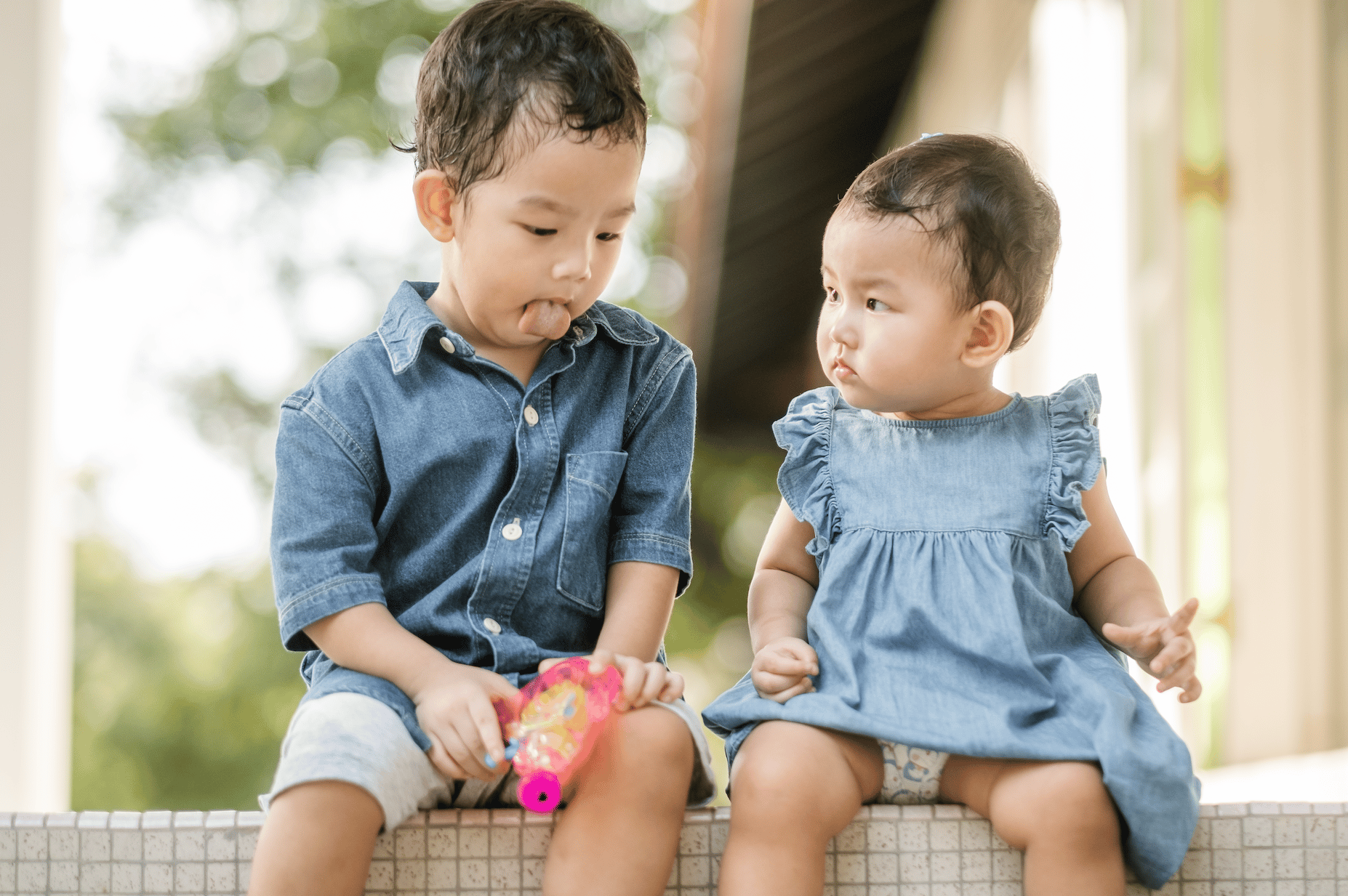 kids sitting on a bench outdoors